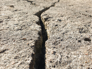 Crack in the stone. A crack, crevice in concrete stone, concrete surface. Authentic damaged concrete slab, crack in foundation,concrete.