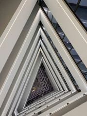 Interior of modern, triangular-shaped, illuminated staircase