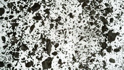 Charcoals with dust explosion, close up, top view on white background