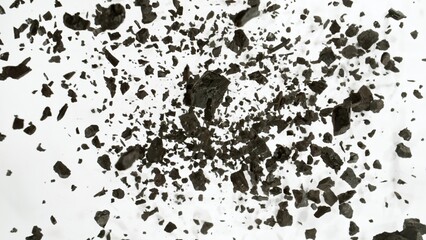 Charcoals with dust explosion, close up, top view on white background