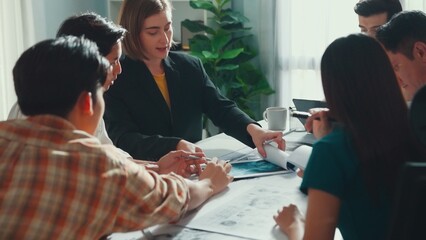 Group of diverse team planning strategy while sitting at table with project plan. Top aerial view of smart business people working together to brainstorm and design house construction. Alimentation.
