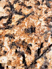Natural granite Royal Gold. Brown stone background with golden veins.Granite Marble Background