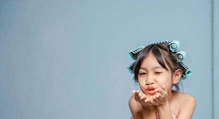 A girl is using hair rollers. hair curling, hair rollers, perm hair.