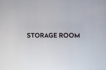 Storage room sign on a plain wall in an indoor facility