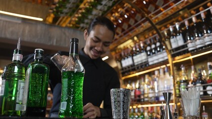 Asian bartender pouring mixed cocktail juice liqueur all ingredient into sliver shaker alcohol drink, making special advertisement creative tasty, focused refreshing showcase at bar luxury. Vinosity.