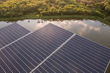 Aerial view of floating solar panels on a river, part of a hydroelectric power plant using...