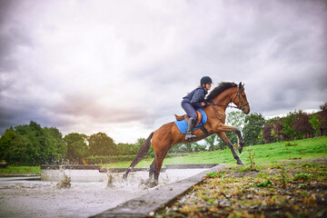 Equestrian girl, splash and horse in action, running and outdoor for sport hobby, fun and bonding...