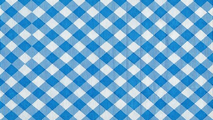 Traditional Bavarian checkered pattern, Schottenmuster, on a bright blue and white fabric, often used for aprons, tablecloths, and rustic home decor accessories.