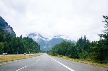 Naklejka premium Highway in Hope BC, Canada with cloud covered mountains in the background