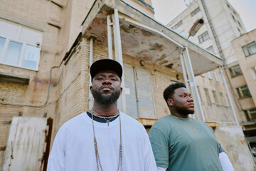 Bad guys standing next to old building in neighborhood