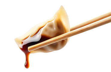 Delicious dumpling held with chopsticks, dripping soy sauce, cut out