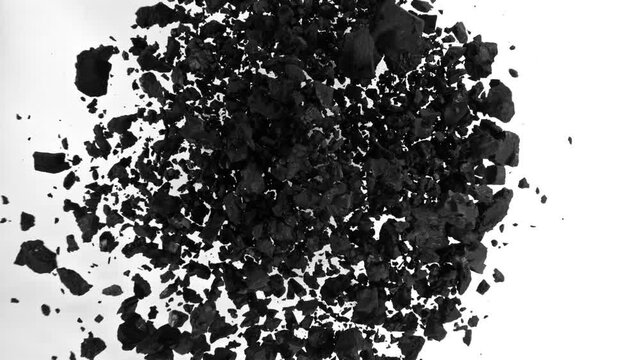 Super Slow Motion of Flying Black Coal Particles. Filmed on High Speed Cinema Camera, 1000fps. Isolated on White Background.