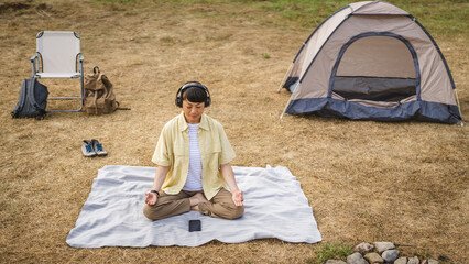 Japanese woman practice guided meditation manifestation in front tent