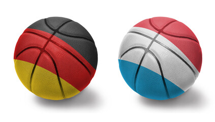 basketball balls with the national flags of luxembourg and germany on the white background.