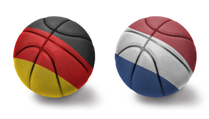 basketball balls with the national flags of netherlands and germany on the white background.