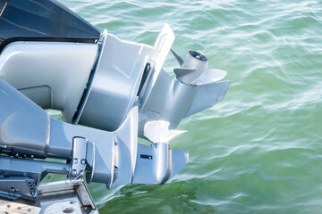 Outboard engine propeller on motorboat closeup on sea waters background © varbenov