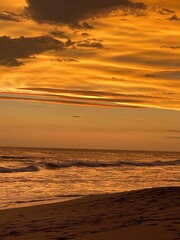 Vibrant Yellow-Orange Sunset: Serene and Atmospheric Evening Sky © Angela