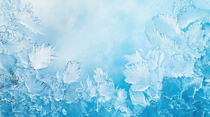 Fototapeta premium Frosty patterns on window glass, blue background. 