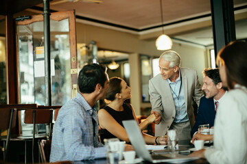 Business meeting with colleagues discussing ideas over coffee in a casual setting