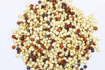Top view. Heap of quinoa seeds on white background.