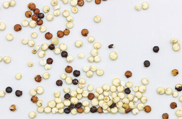 Quinoa seeds scattered on white background