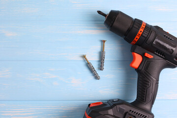 Cordless Drill Featuring Various Drill Bits Set Against a Vibrant Blue Background