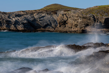 Waves crashing on rocks in newquay, cornwall, england