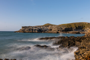 Waves crashing on rocks at newquay beach headland