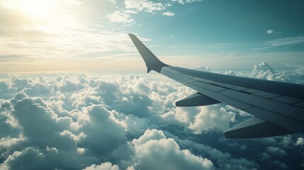 Obraz premium Through an airplane window, a breathtaking panorama unfolds: a tapestry of clouds billowing softly below, their ethereal forms casting an enchanting spell.