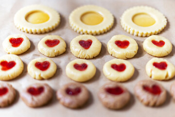 homemade cookies with jam on a baking sheet. preparation for baking.