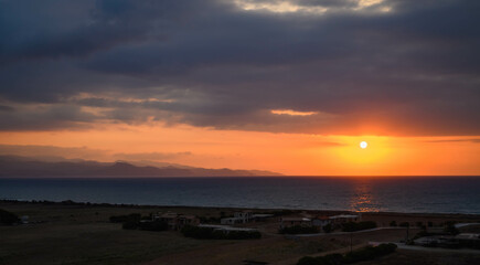beautiful sunset with view of Mediterranean sea and mountains island of Cyprus