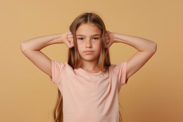 Fototapeta premium A young child shielding her ears with her hands