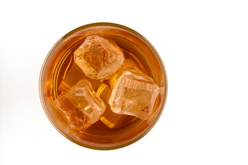 Aerial view of a glass with whiskey and ice cubes