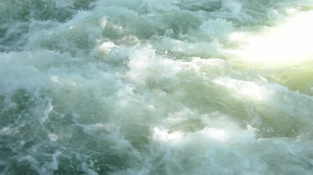 The wild waters of the Eisbach wave of the River Isar in Munich.