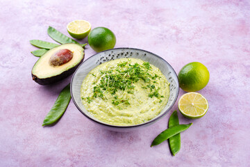 Traditional exotic spring dip with avocado and roasted vegetables served as close-up in a Nordic design bowl