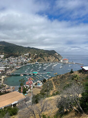 View of the Catalina Island Harbor with Boats Docked in the Water Under a Cloudy Sky in California