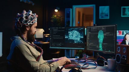 Computer engineer using EEG headset, starting mind upload process using brain machine interface. Man using neuroscientific device to transfer consciousness into cyberspace, typing code, camera B