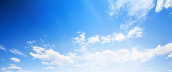 Fototapeta premium Panoramic View of a Clear Blue Sky with Clouds and White Space at the Bottom, High-Resolution, Minimalistic Design