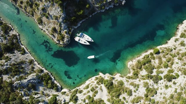 Cinematic aerial shots of a sailing boat in Croatia's Kornati archipelago. Crystal-clear waters, serene bays, and vibrant holiday scenes. Perfect for luxury travel, adventure, and summer vacation.