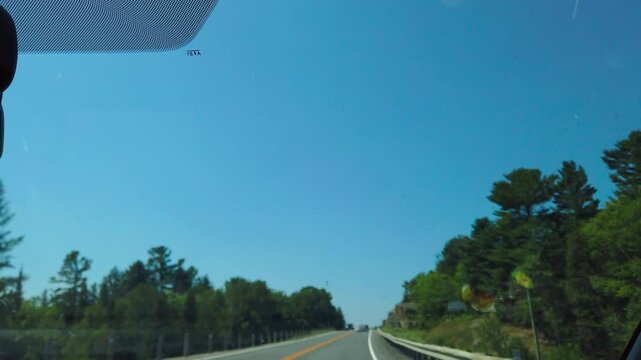 Driving along a scenic road towards Sudbury in Ontario, Canada.