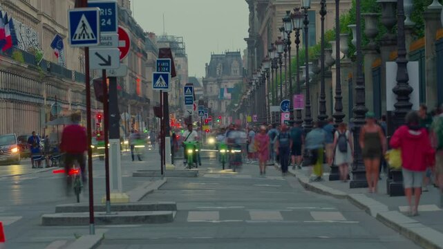Longest, famous street in Paris, natural extension of the Champs-Elysees. Cyclists and crowds of people. Main street with bicycle, people. City traffic in the city center France