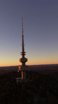 Aerial view at sunset rotating around the Telstra Tower in Canberra. The capital of Australia