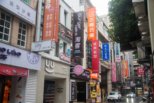 Scenery of street traffic in Taipei with difference dvertisement billboards of shops and stores along the road.