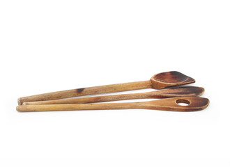 Old wooden kitchen spoon set. Blackened and burned spatula and spoon. Concept for when to replace wood kitchen utensils. White background. Selective focus.