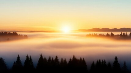 Obraz premium Breathtaking sunrise over a foggy landscape, creating a peaceful atmosphere with silhouetted trees and distant mountains.