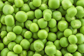 Fresh green peas as background, top view