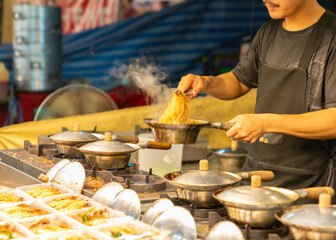 A chef is making baked shrimp with glass noodles to sell.