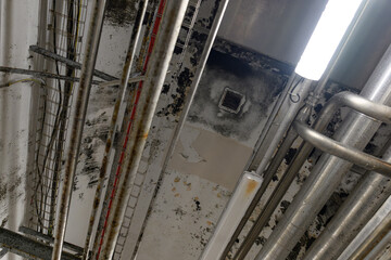 Mold on the ceiling near the ventilation grill in the food industry.