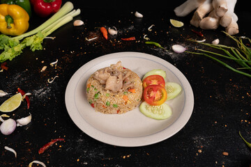Hearty pork fried rice with a fresh veggie garnish – the perfect comfort food.