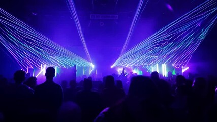 Crowd enjoying live music performance with laser lights - Powered by Adobe